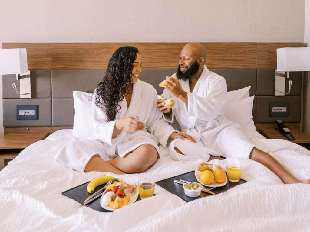 Couple enjoying breakfast in hotel room